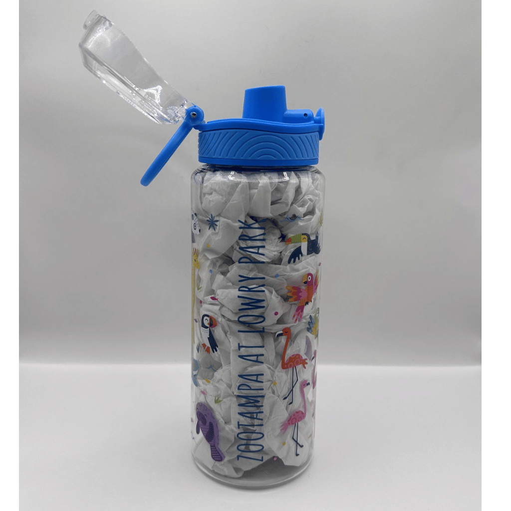 A clear plastic water bottle with a blue flip-top lid, filled with white crumpled paper and decorated with colorful cartoon animals and the text 'ZOO TAMPA AT LOWRY PARK'.